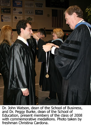 Students from the class of 2008 are presented with commemorative medallions.