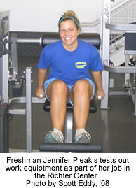 Freshman Jennifer Pleakis tests out work equipment as part of her job in the Richter Center.  Photo by Scott Eddy, '08.