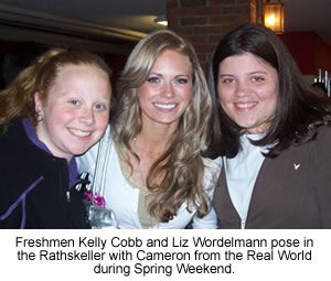 Freshmen Kelly Cobb and Liz Wordelmann pose in the Rathskeller with Cameron from the Real World during Spring Weekend