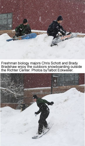 Students snowboarding outside the Richter Center.