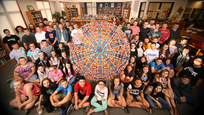 Linda Dodd-Nagel, her 8th-grade math students, Tae Cooke, and Chris Hill surround the runcitruncated hypericosahedron
