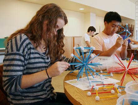 Nicole builds a truncated icosahedron while Andy constructs an elevated icosahedron.