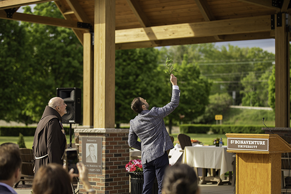 Luke Marchiori blesses the pavilion as Fr. Dan Riley looks on.