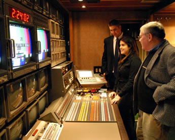 Seniors Jeff Landers of Marathon and Meghan Rossman of Lewiston look over the equipment in the tv production truck with Paul Wieland, SBU faculty member