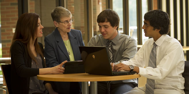 Pictured: Sr. Margaret Carney, O.S.F., speaks with seniors in the Swan Business Center