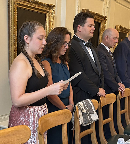 Alyssa Perkins, speaking in the Seneca language, invokes blessings on the meal at Trinity College