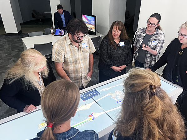 Health educators work on an Anatomage table at SBU