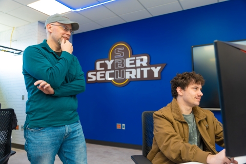 Brian Kellogg, MS CYB program director, in new cybersecurity center with student