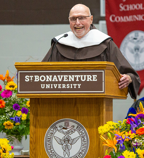 Fr. Dan at the podium