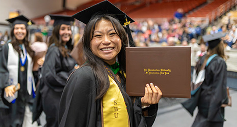 Graduate with diploma.