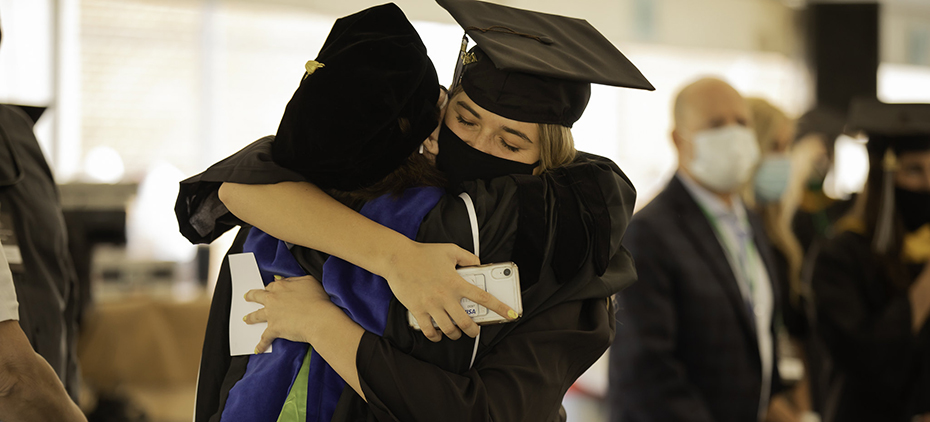 A student hugs a professor