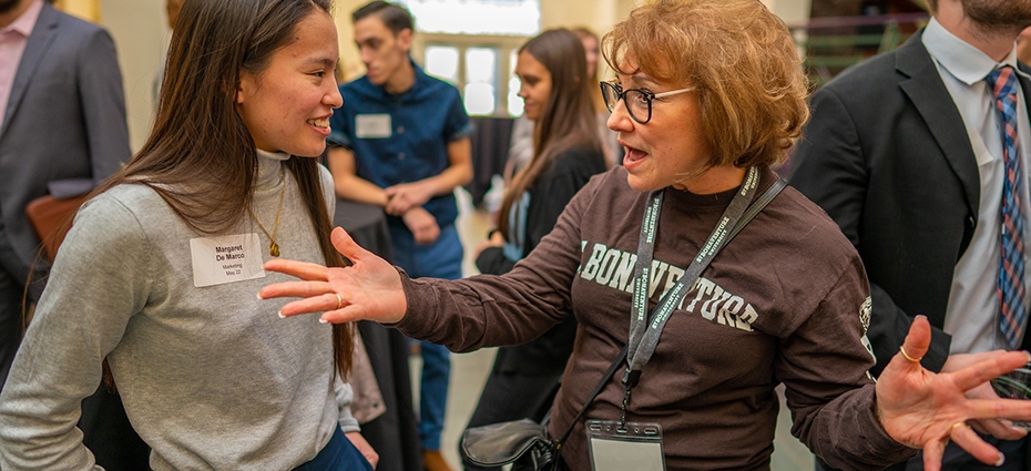 Student and alumna talking at a Bonnies 4 Bonnies event