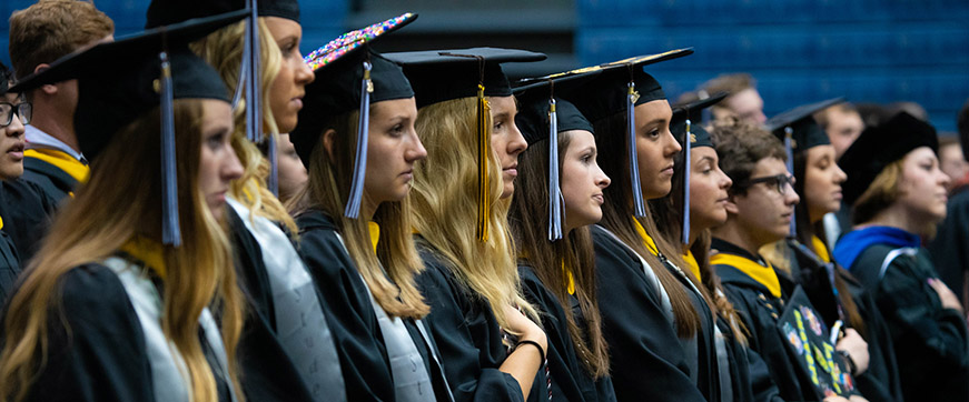 Students in caps and gowns at commencement