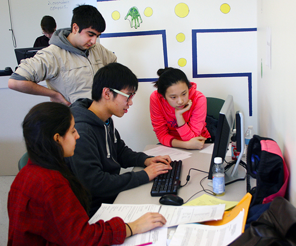 A team of students working on a computer programming problem