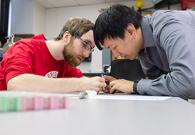 A student and teacher analyze data.