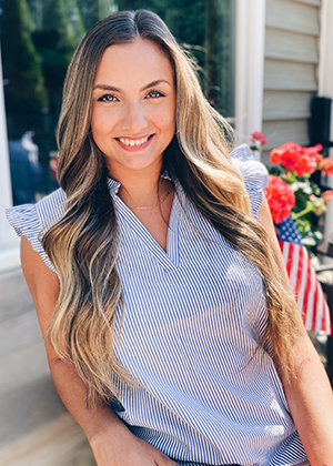 Alexandra poses outside of her home