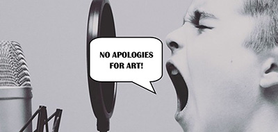 Boy yelling "No apologies for art!" into a microphone