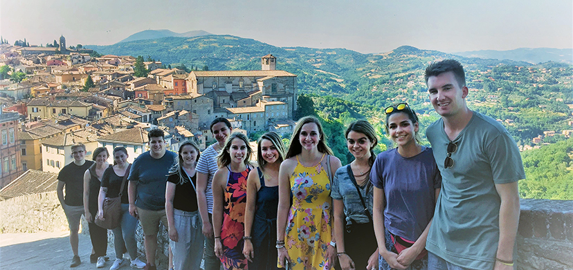 Summer study in Perugia students on a hillside overlooking the city.