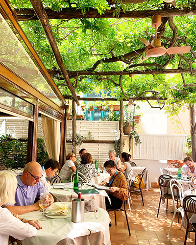 Diners at an outdoor garden restaurant in Sorrento