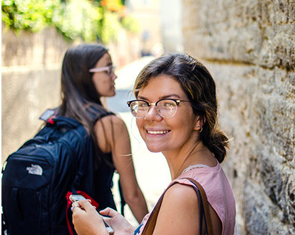 Two female students walking about Pompeii