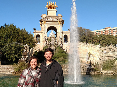 Two study abroad students by a fountain in Seville, Spain