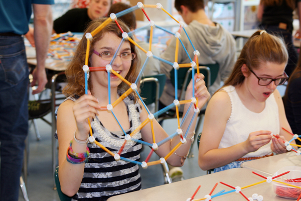 A good strategy is to first build the top and bottom halves... A student shows the half of a module she had built.