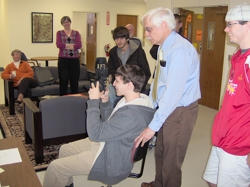 A student uses a bubble sextant as Phil Winger provides "turbulence." A student uses a bubble sextant as Phil Winger jostles his chair to create "turbulence."