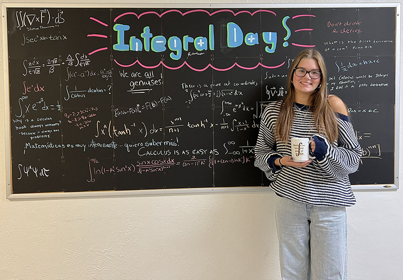 Alena Kilminster stands with her prize in front of the Integral Day display