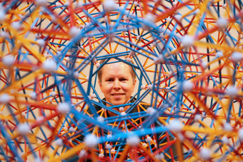Dr. Hill peering through a Zometool model of an expanded hyperdodecahedron