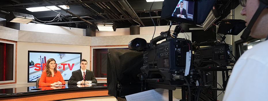 Student operates a camera during an SBU-TV newscast