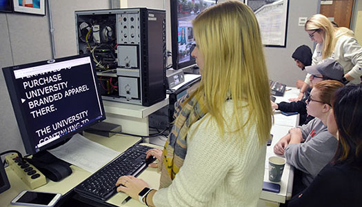 Students work in the control room at the Koop Lab