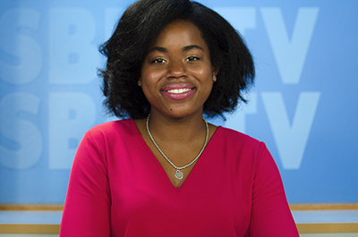 Jandoli School Female student at the SBU-TV news anchor desk.