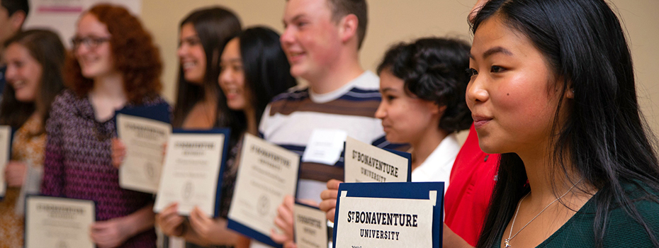 High school STEM students holding certificates