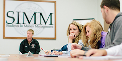 Students conferring during a SIMM meeting