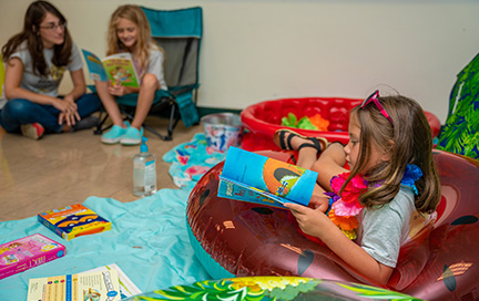 A child reading in a bean bag chair.