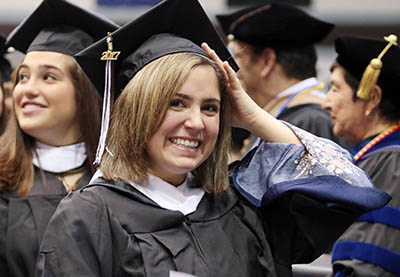 Graduate adjusting her cap