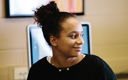 Student in front of a computer terminal