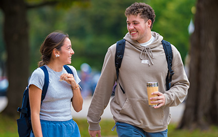 Two students walk outside.