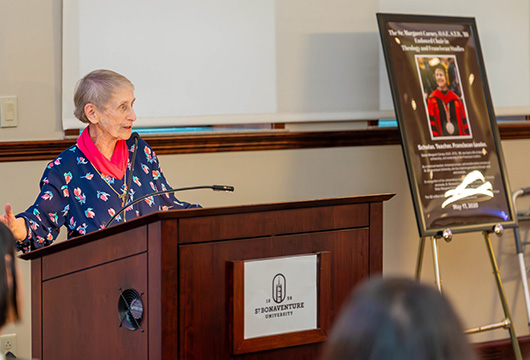 Sr. Margaret Carney, O.S.F., S.T.D., at the podium.