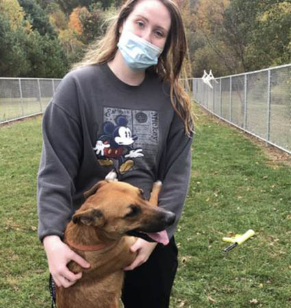 Kaitlin Sinclair walks a dog at the SPCA
