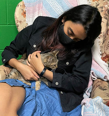 Pictured_Bona student Neeya Shetty visits with a four-legged friend at the local SPCA