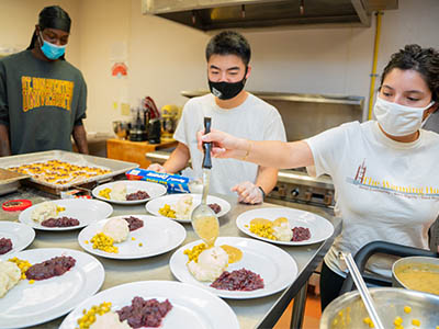 Pictured_Bona students prepare to serve meals at the Warming House