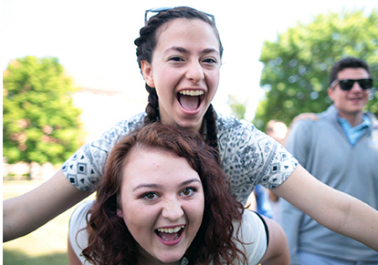 A student getting a piggyback ride from another during St. Bonaventure Orientation