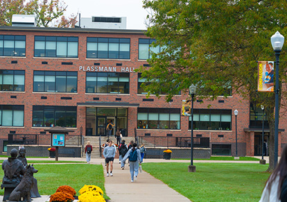 plassmann-hall-front-414 Students walking near Plassmann Hall.