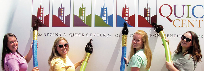 Students posing in front of the Quick Center's Artmobile