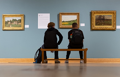 Students looking at art in a Quick Center gallery