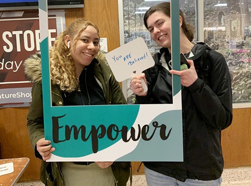 Students holding Empower sign Students holding Empower sign