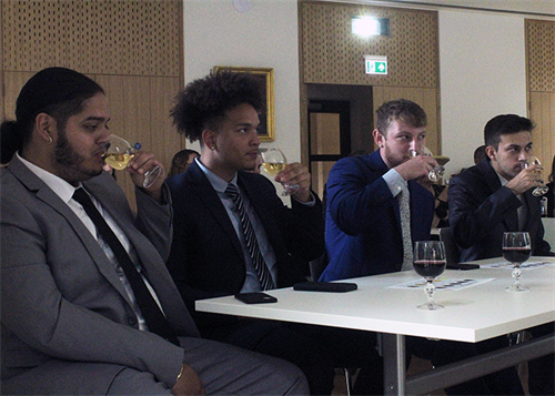 St. Bonaventure students Jerson Segovia, Deandre Allen, Dakoda Iamele and Matthew Salewski consider the color, age, aroma and “legs” of the sauvignon blanc from New Zealand.