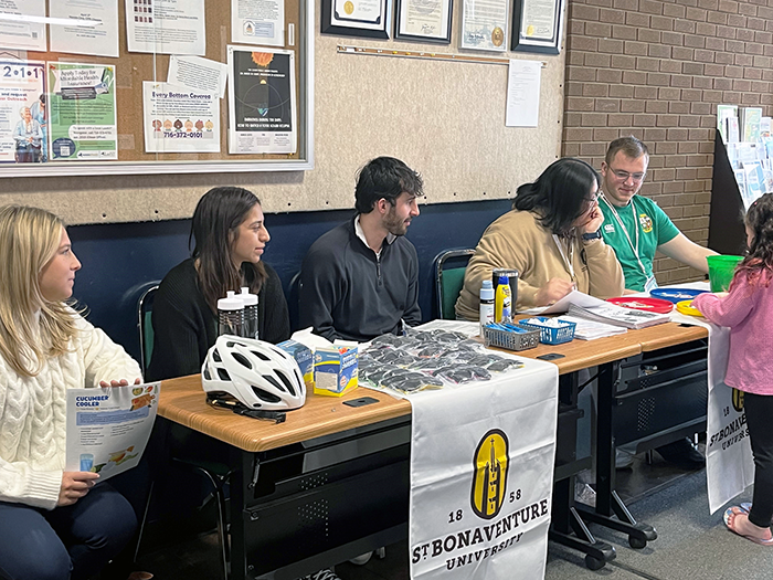 St. Bonaventure Mother Cabrini interns chat with children and their families about tips and ways to keep safe during the summer months.