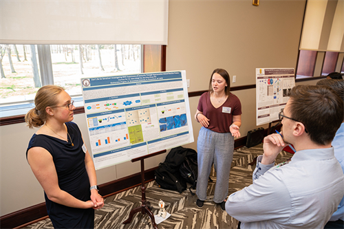 Claire Schaef (left) and Courtney Fox presented their biochemistry research at the 2022 Arts & Sciences Expo on campus.